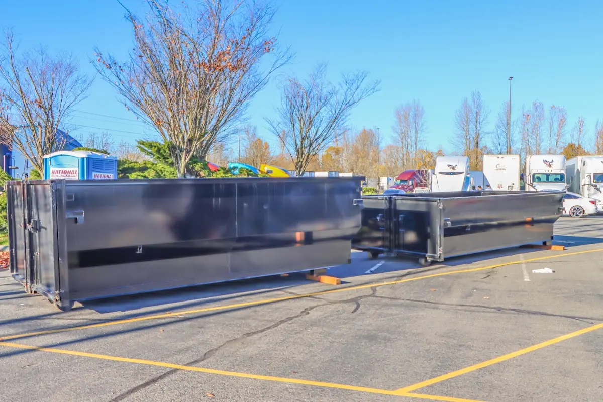 Professional dumpster rental service with roll-off container on residential driveway in Staunton